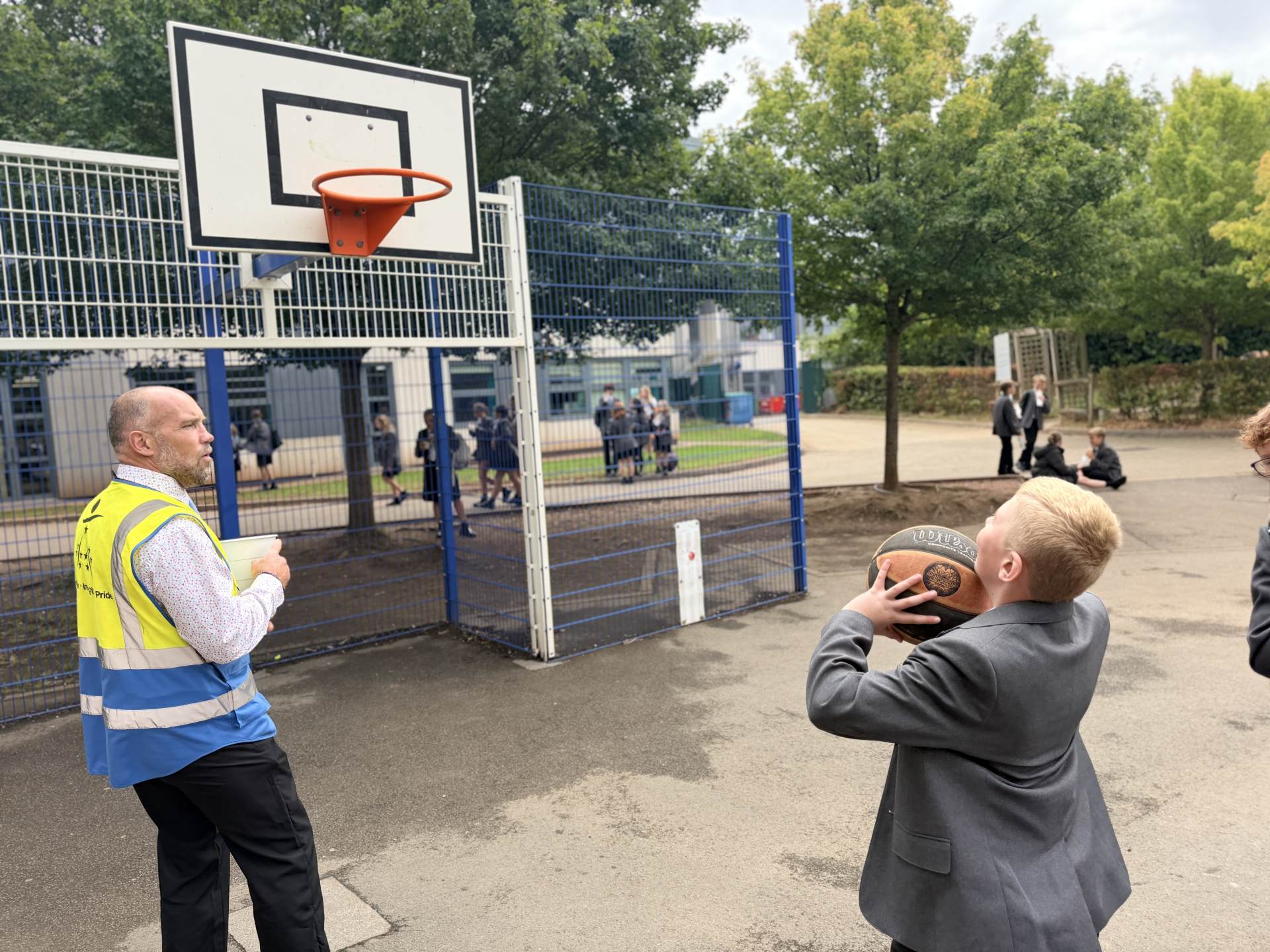 A Year 7 student taking a basketball shot